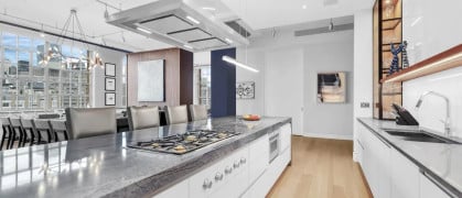 A brightly lit open kitchen with modern clean style and appliances