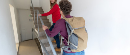 tourists climbing the stairs to their short-term rental in nyc