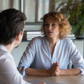 two people negotiating a deal at a table.