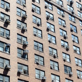 NYC apartment building with AC units