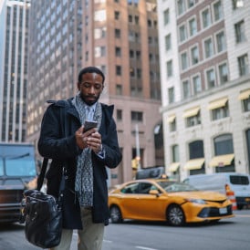 Man looking at his phone in NYC street