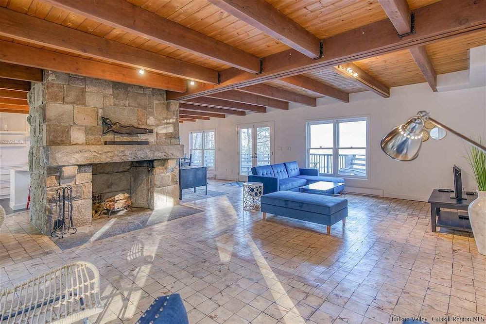 A house in Woodstock, NY, with a stone tower and mountain views, for