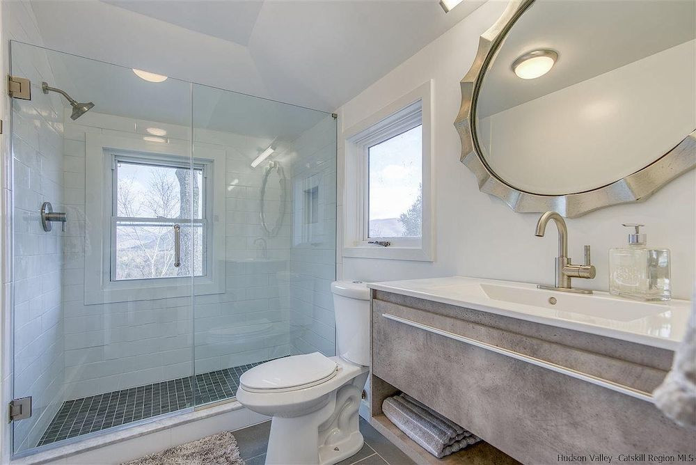 A house in Woodstock, NY, with a stone tower and mountain views, for