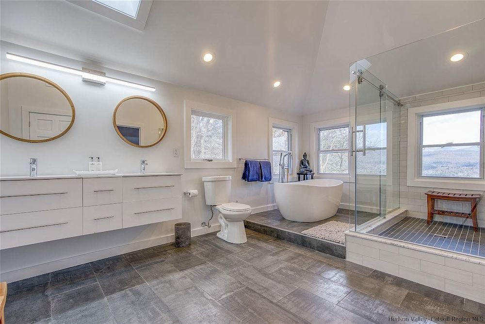 A house in Woodstock, NY, with a stone tower and mountain views, for