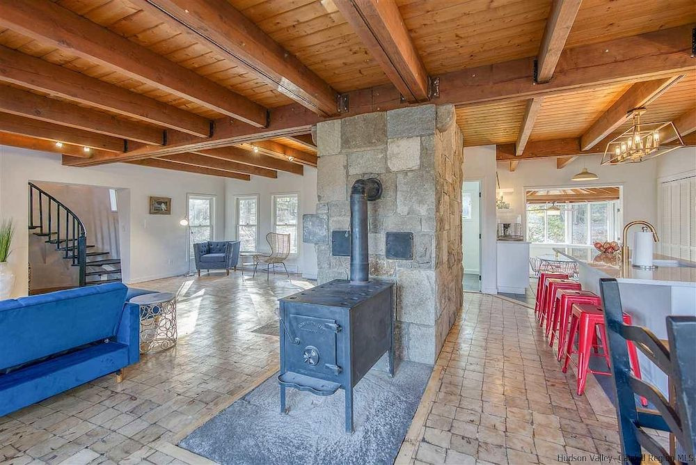 A house in Woodstock, NY, with a stone tower and mountain views, for