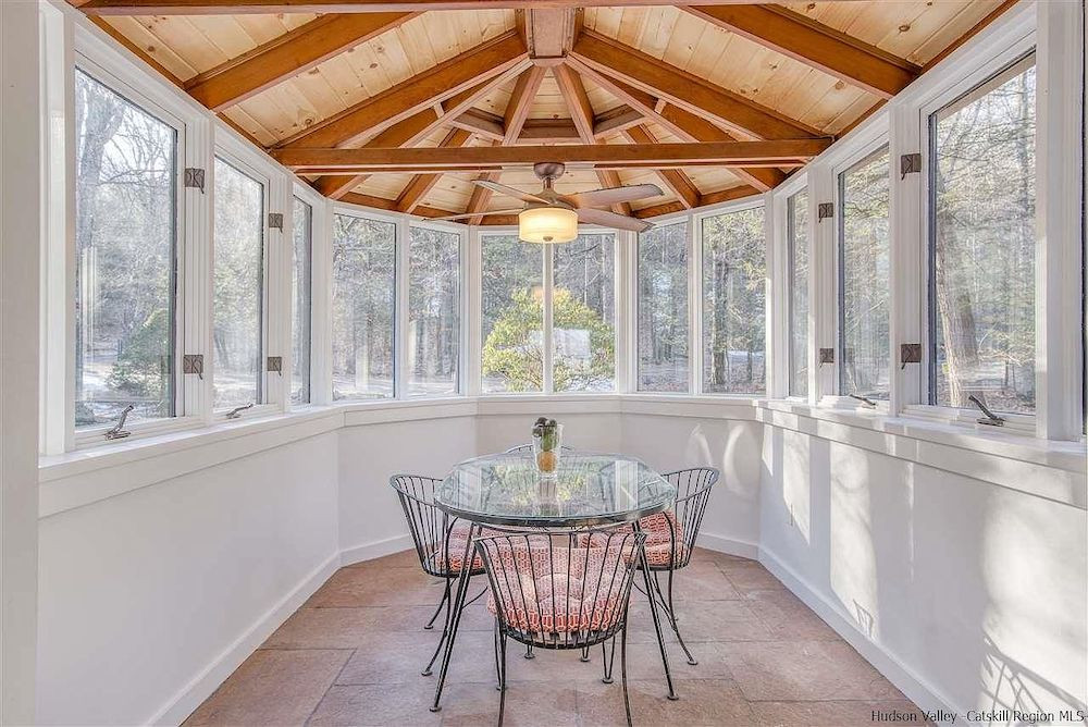 A house in Woodstock, NY, with a stone tower and mountain views, for