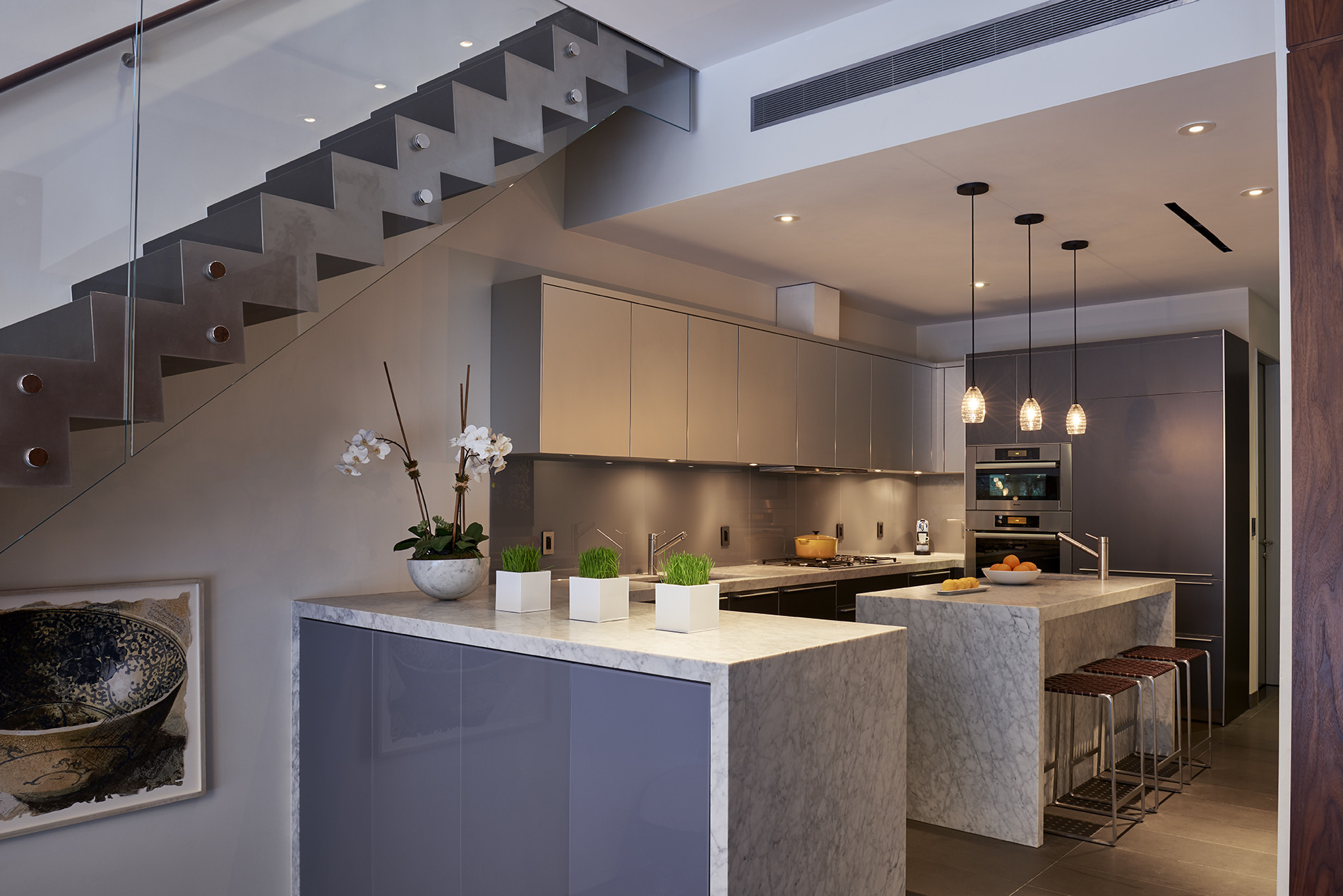 What are waterfall kitchen islands and how do I use them in an open plan?