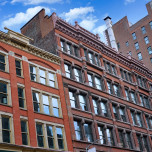 Row of three red brick apartment buildings in NYC