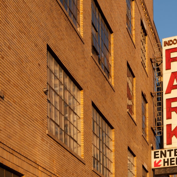 Building garage parking sign during sunset on the west side of Manhattan, New York City.